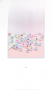 Macro detail of 4x7mm acrylic alphabet beads with colorful letters for DIY jewelry making