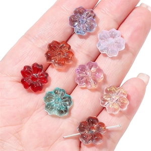 14mm cherry blossom glass beads for DIY jewelry making shown in hand for scale