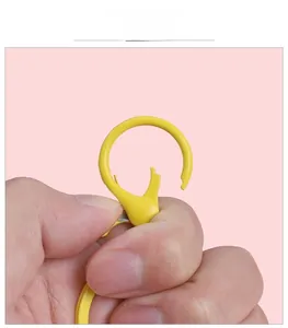 Close-up of yellow candy-colored metal lobster clasp showing the spring hook mechanism