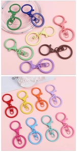 Close-up of colorful painted metal keychains in various vibrant candy-colored finishes