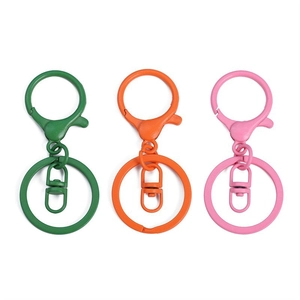 Three-piece colorful metal keychain set with lobster clasps and rings in green orange pink
