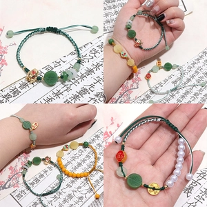 Handcrafted Chinese retro woven bracelets with jade-like beads and lucky charms