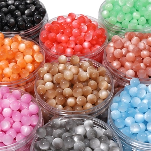 Colorful round resin cat eye beads in various shades for DIY jewelry making and crafts