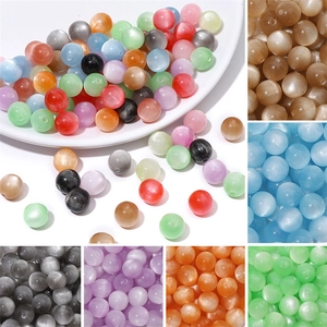 Detailed macro view of assorted colorful resin cat eye beads with light reflection
