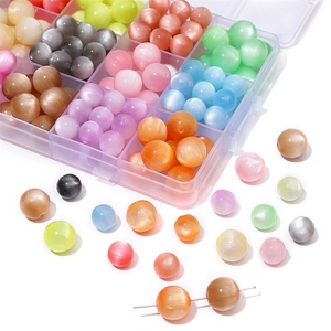 Macro shot of colorful cat-eye resin beads sorted in a plastic organizer for DIY jewelry