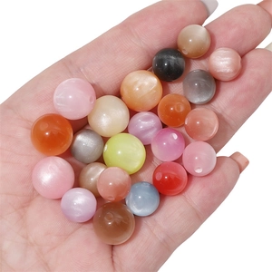 Close-up of colorful resin cat-eye beads with shimmering luster for DIY jewelry making