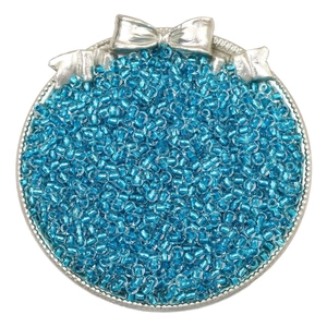 Top view of light blue silver-lined seed beads in a metal container with bow relief