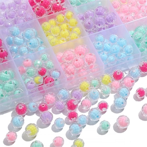 Macro view of colorful striped acrylic beads in a clear storage box for DIY jewelry