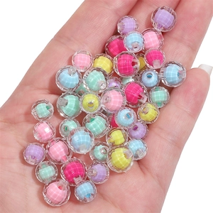 Colorful candy acrylic faceted beads held in hand for DIY jewelry making and crafts