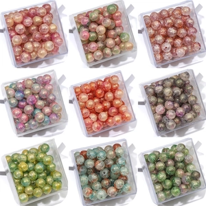 Assorted iridescent glass beads with crackle texture for DIY jewelry in a clear box