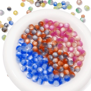 Macro view of colorful resin cat eye beads in various shades for DIY jewelry making