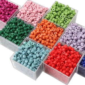 Macro shot of colorful acrylic cylinder beads for DIY jewelry making in various vibrant colors