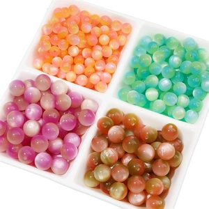 Close-up of cat-eye resin beads in four color sets displayed in square trays