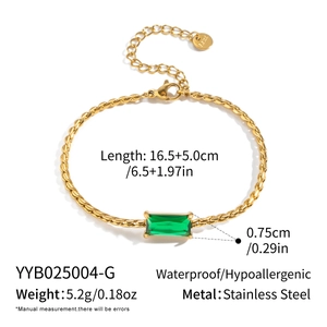 Detail view of gold twisted chain bracelet with green rectangle zircon and lobster clasp
