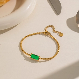 Detail of vintage gold bracelet with rectangular green zircon and lobster clasp