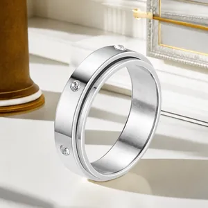 Close-up of a silver titanium steel rotating ring with inlaid cubic zirconia stones