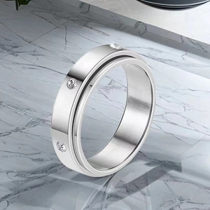 Close-up of a silver stainless steel spinner ring with inlaid clear rhinestones.