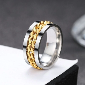 Detailed view of the two-tone stainless steel spinner ring with golden chain inlay