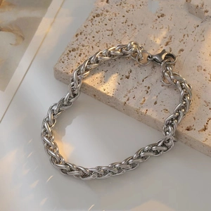 Detailed macro view of 6mm stainless steel dragon bone chain bracelet with lobster clasp
