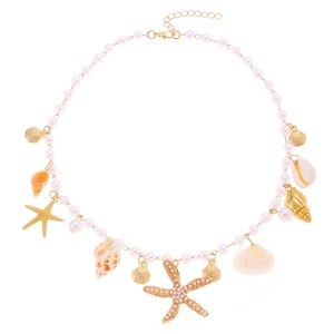 Detail of bohemian pearl necklace featuring gold sea shells, starfish, and conch pendants