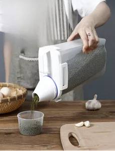 Kitchen cereal dispenser detail showing tapered spout pouring green beans into measuring cup