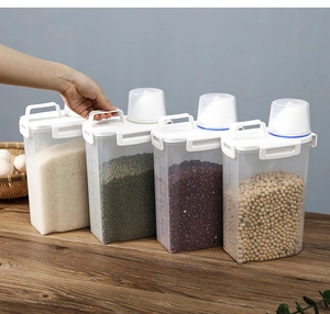 Detail view of clear grain storage containers with measuring cups and handle lids