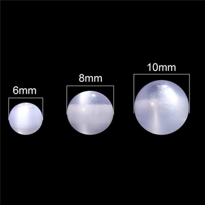 Three sizes of white cat eye resin beads shown in 6mm, 8mm, and 10mm diameters on black background