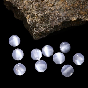 Macro detail of round cat eye resin beads in light purple for DIY jewelry making