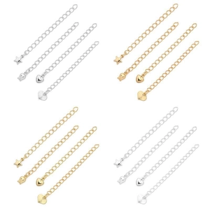 Detail view of gold and silver plated extension chains with heart and star pendants