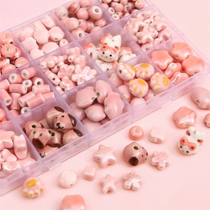 Pink ceramic bead set with cat and flower shapes in a transparent storage box