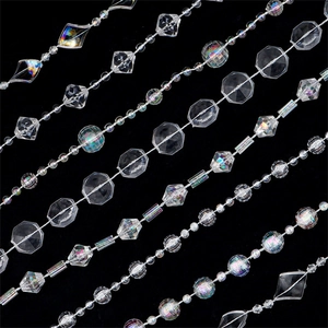 Detailed macro view of assorted clear acrylic crystal beads in geometric cuts and shapes