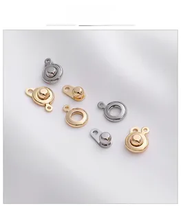 Detail of 18K gold and silver plated lobster clasps for DIY jewelry making on white silk