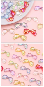 Macro detail of acrylic aurora butterfly beads for DIY jewelry and phone chain decor