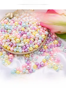 Macro shot of colorful ABS faux pearls for DIY jewelry making in a decorative gold dish