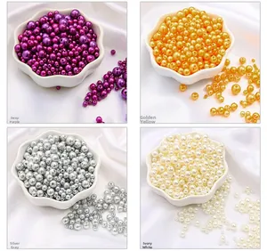 Detail of candy-colored ABS pearl beads in deep purple, gold, silver, and cream