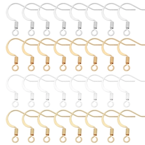 Macro view of gold and silver DIY earring hooks with spiral coils and loops on white background