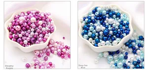 Macro shot of mixed size purple and blue faux pearls in a ceramic petal bowl for DIY crafts