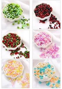 Macro view of colorful ABS faux pearls in floral dishes for DIY jewelry crafts