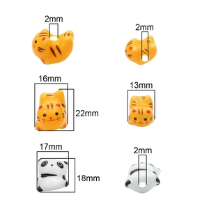 Hand-painted ceramic animal beads featuring panda and tiger designs for DIY jewelry making