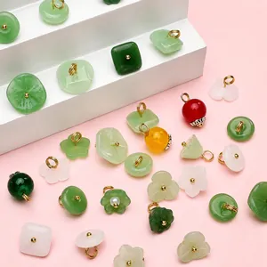 Macro shot of lily of the valley glass beads and vintage style Chinese flower charms