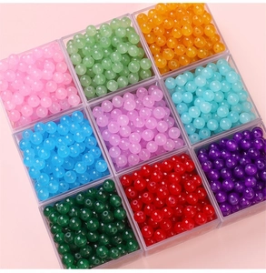 Colorful 6mm and 8mm round glass beads in 9 colors organized in a clear grid storage box