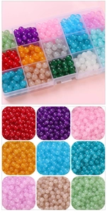 Macro detail of assorted colorful jelly glass beads in a clear plastic storage box