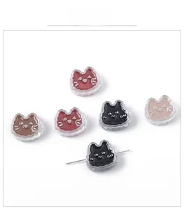 Detail showing acrylic cat-shaped charms with colorful cores and horizontal drill holes