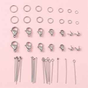 Stainless steel jewelry making kit with lobster clasps and jump rings on pink background