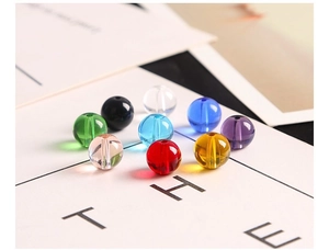 Detailed view of colorful polished glass beads with pre-drilled holes for DIY jewelry