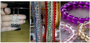 Close-up of colorful translucent glass beads and butterfly pendants for DIY jewelry making