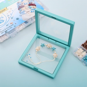 Close-up of mint green floating jewelry box with ocean-themed beaded turtle bracelet