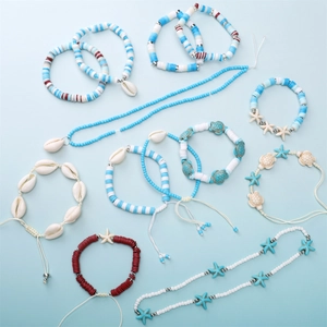 Detail of beach jewelry set featuring blue heishi beads, sea shells and starfish charms