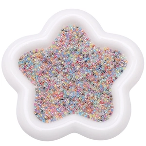 Colorful 2-4mm pearlescent glass seed beads in a star-shaped tray for DIY jewelry