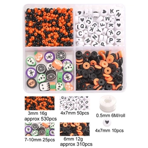 Halloween DIY jewelry kit with orange and black beads, clay charms, and elastic string
